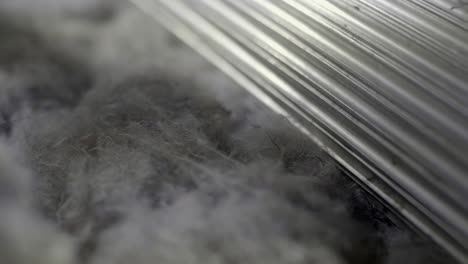 closeup of recycled textiles manufacturing, processed on a industrial spinning machine