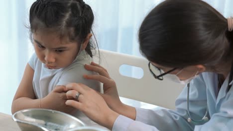 school girl visits skillful doctor at hospital for vaccination