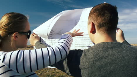 Young-people-discussing-future-construction-on-the-open-territory