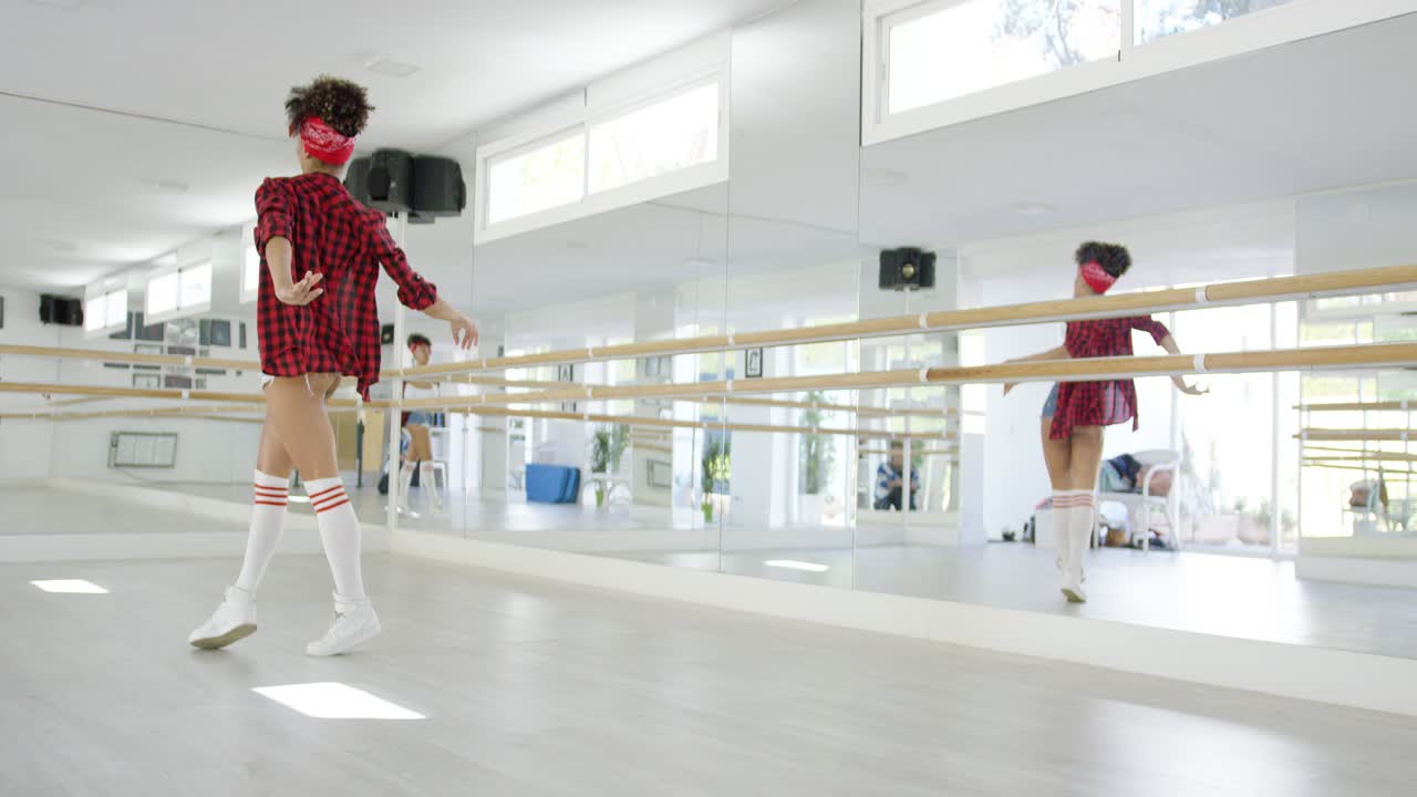 Female dancing student takes steps in studio