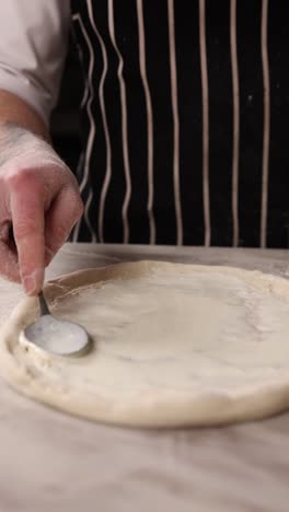 chef preparing a pizza base