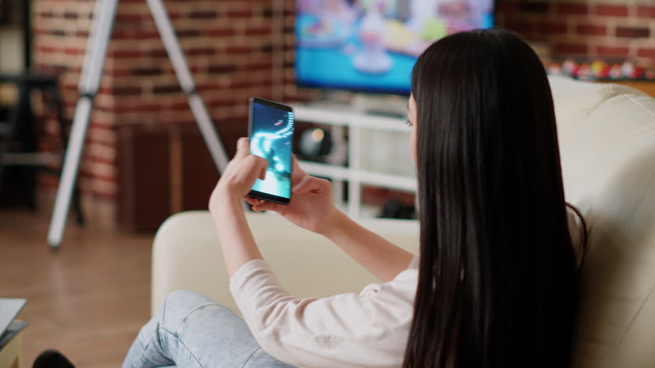 Woman playing mobile game on smartphone