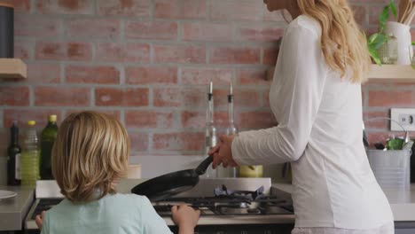 Mother and son preparing food in kitchen at comfortable home 4k