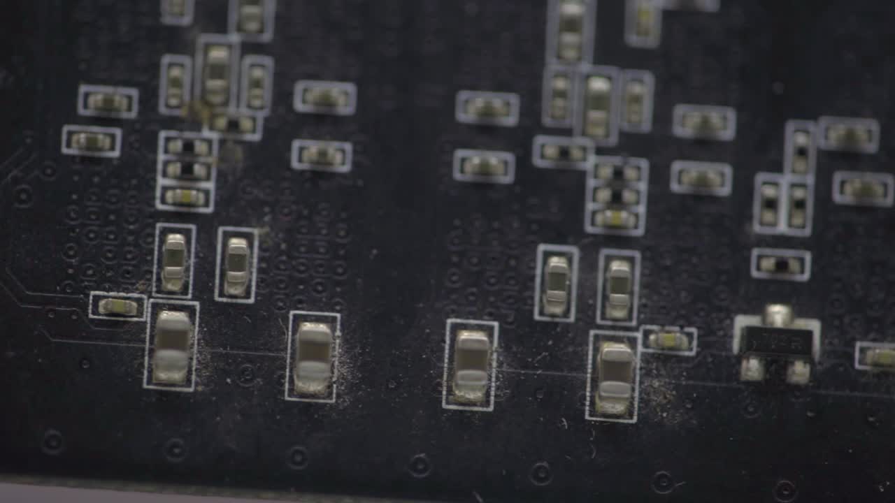 Top View Of A Motherboard With Soldered Surface Mount Parts And Components - macro - trucking shot