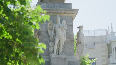 focus pull from lush trees to statues in madrid, spain