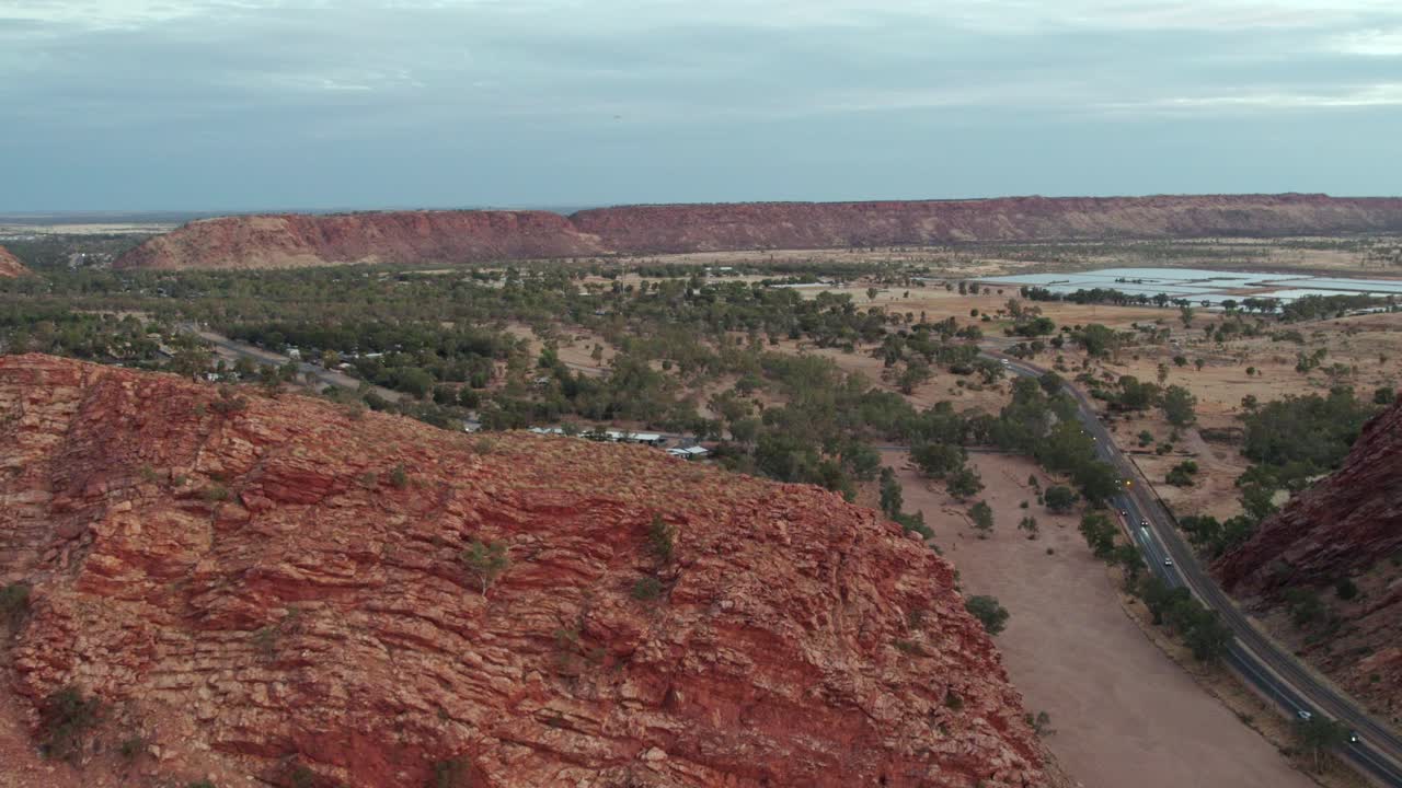 Reversing aerial footage ver the ridge at Heavitree Gap, Alice Springs, Mparntwe. Northern Territory, Australia. August 2022.