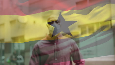 animación de la bandera de ghana ondeando sobre un hombre que usa una máscara facial durante la pandemia de covid-19