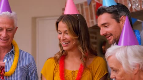 animation of burning layer over family having fun at birthday party