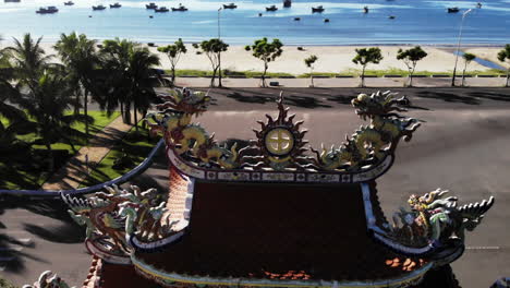 Traditional-Vietnamese-decoration-on-roof-of-ancient-buddhist-temple-entrance,-aerial