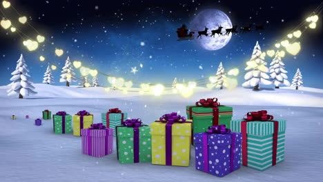 animation of christmas decorations over winter scenery with presents and santa in sleigh
