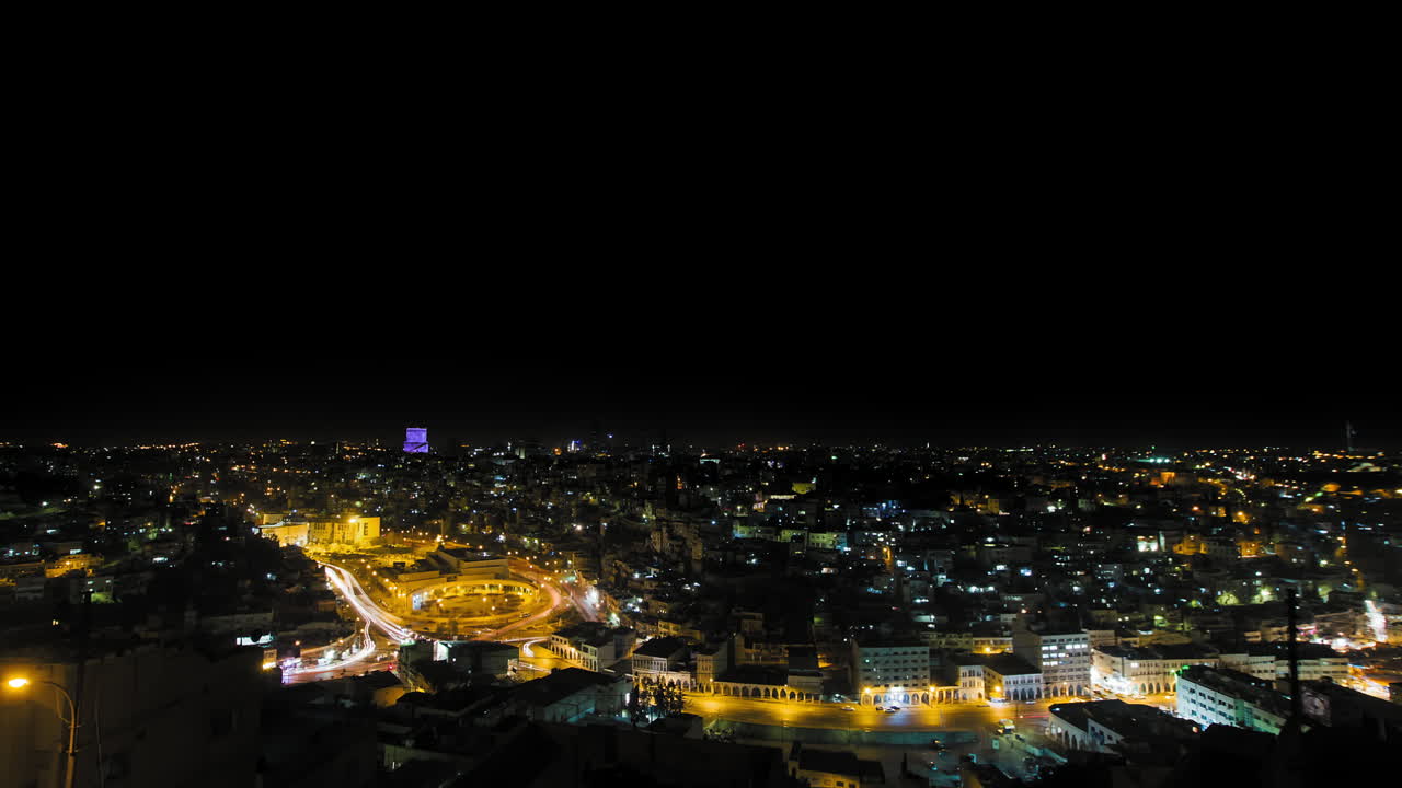 Amman at night, Jordan. Wide shot dolly right, downtown Amman, city center, Hyperlapse with very busy movement at night. 4K