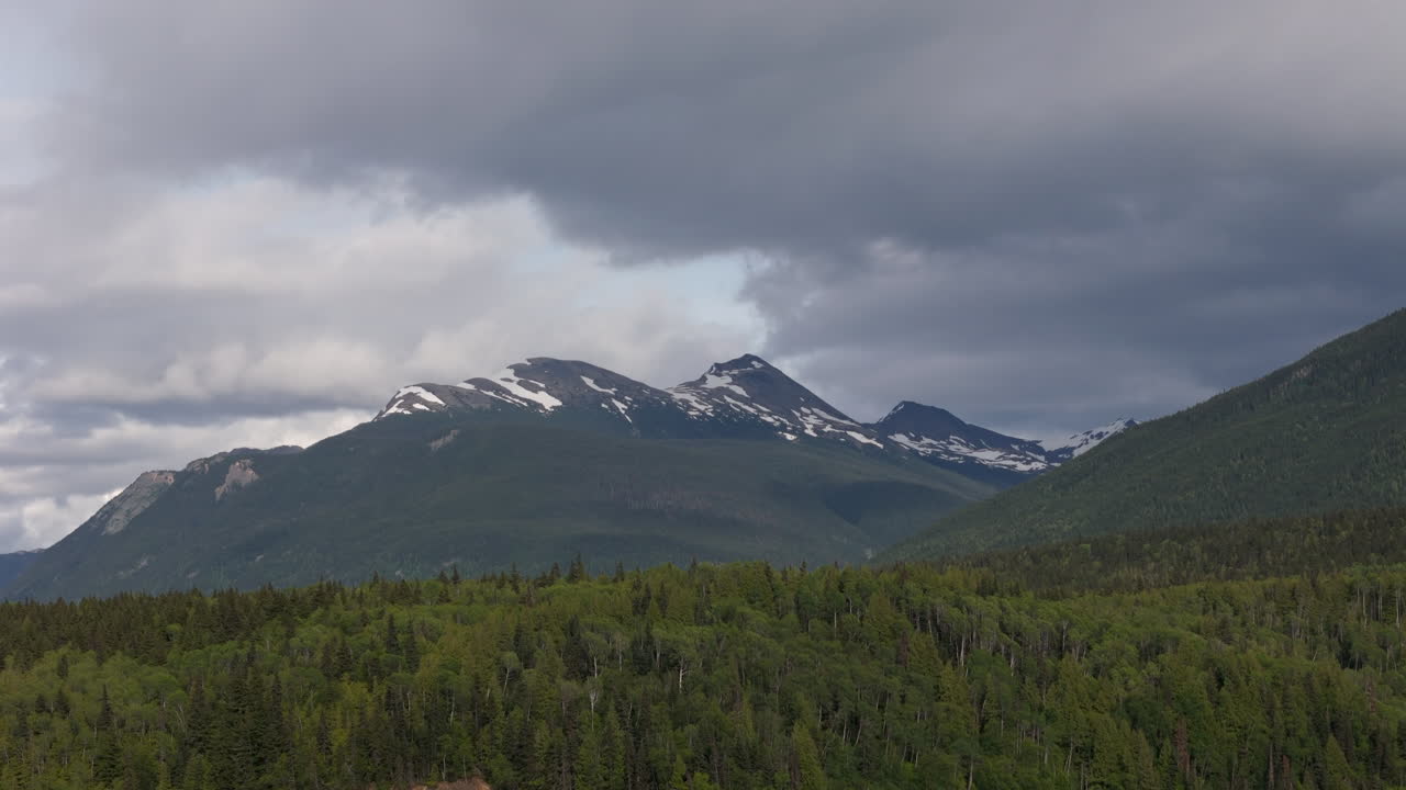 Towering mountains with lush green Yukon wilderness