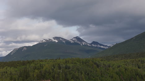 towering mountains with lush green yukon wilderness