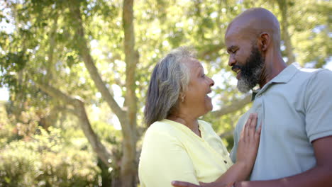 embracing and enjoying moment, smiling senior couple together outdoors
