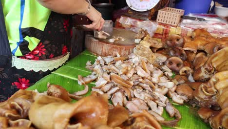 vendor slicing and arranging pork for sale.