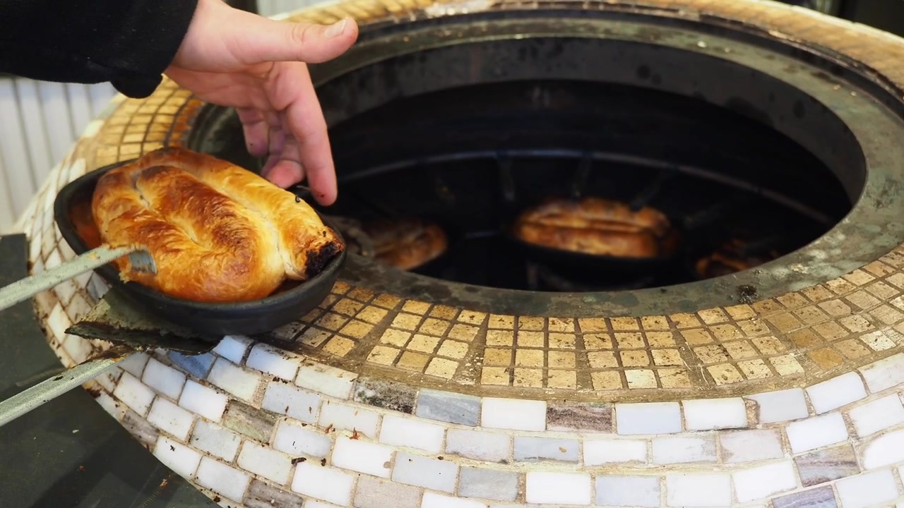 Baking Golden Brown Pastry in a Traditional Tandoor Oven
