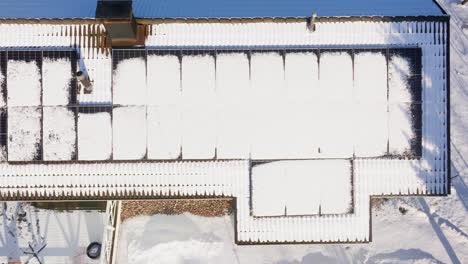 birds eye drone shot above rooftop solar panels melting in warm, spring sunlight