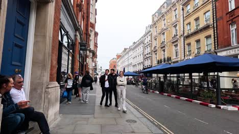 people walking and cycling on a london street