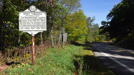 an antique historical road sign welcomes visitors to west virginia