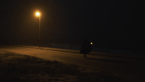 in a dark street a serial killer looks for his victims at night amid terror
