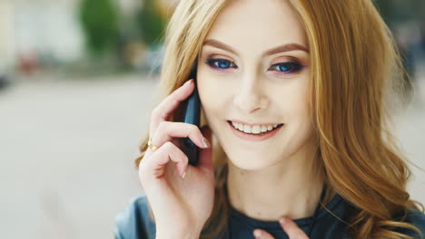 Beautiful-Woman-With-Long-Hair-Talking-On-The-Phone-Outdoors