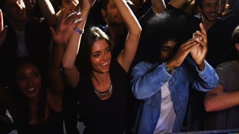 group of people dancing at a concert 4k