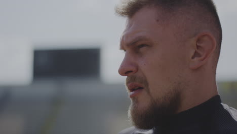 man in profile view at stadium