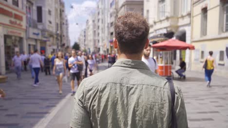 young man walking in the crowd.