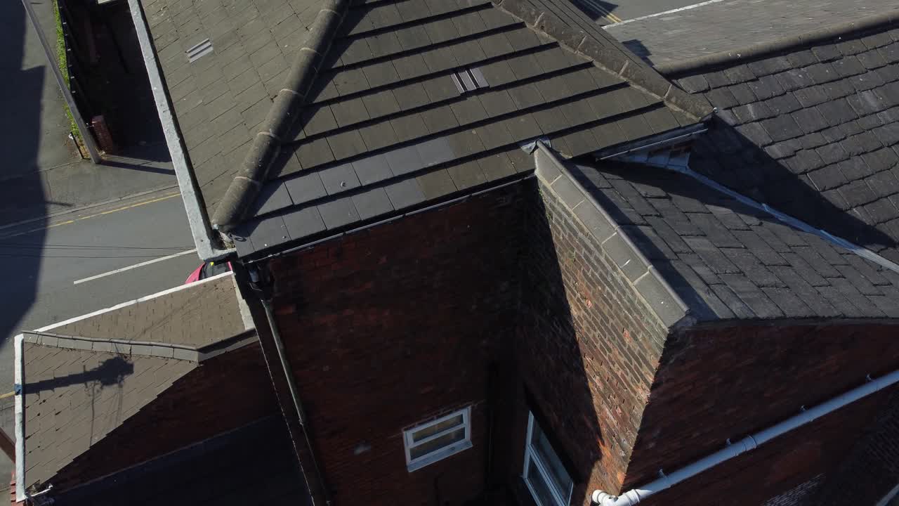 Rooftop inspection aerial view inspecting damage and repair of real estate evaluation for homeowner