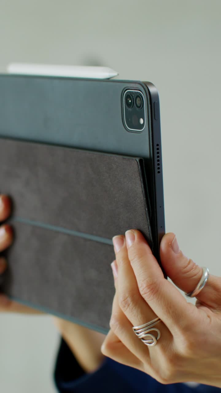 Woman holding a tablet with a protective case