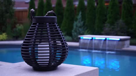 linterna en el pilar del patio con piscina y fuentes al fondo