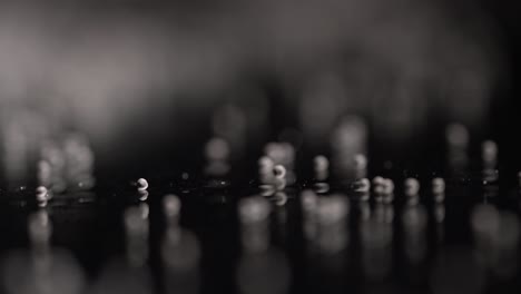 small white spheres on a dark surface