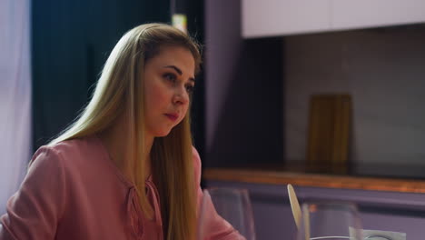 worried lady looks disbelievingly at partner at dinner