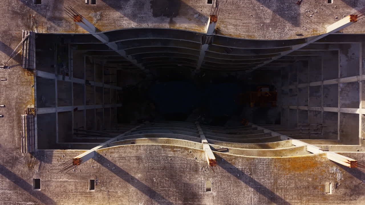 Exploration of an abandoned structure reveals intricate shadows and a mysterious void under the setting sun at twilight