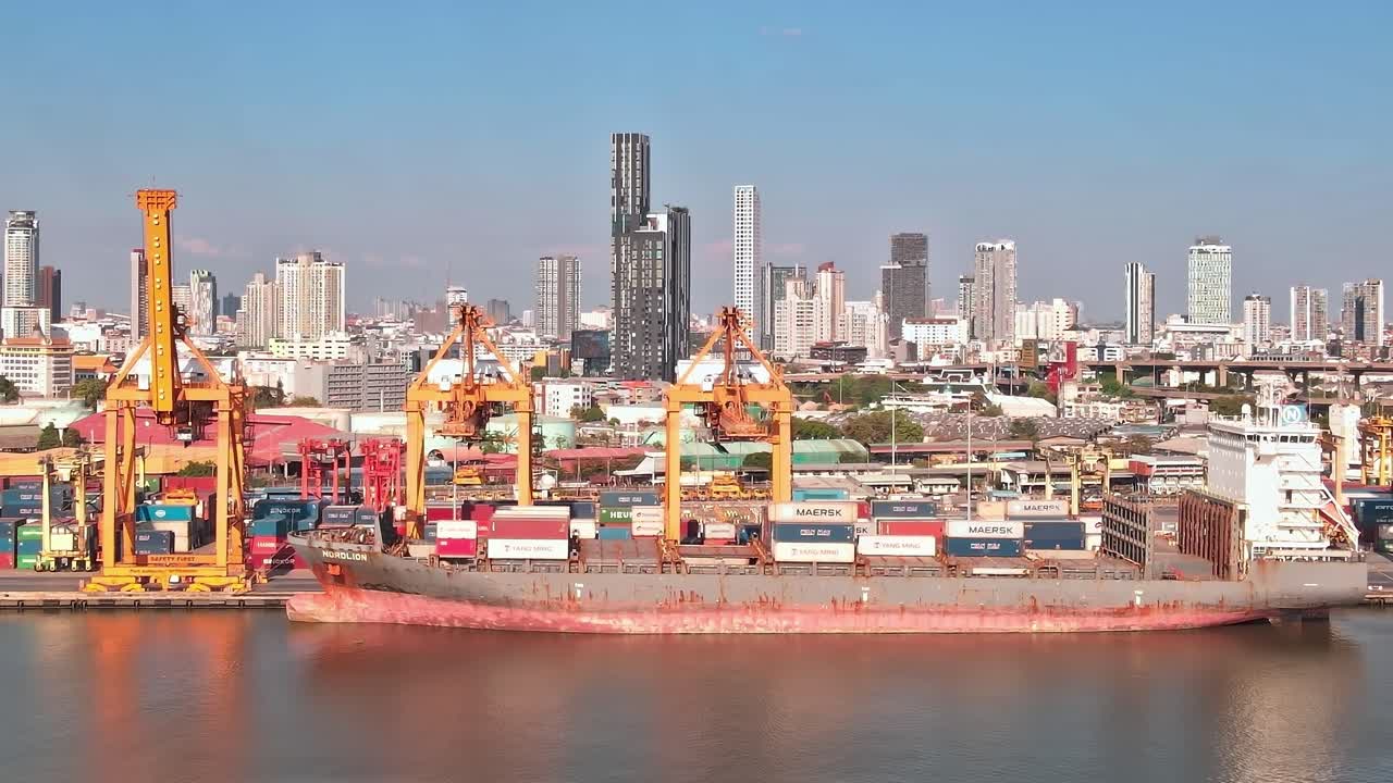 View of Bangkok harbor with shipping containers and city skyline