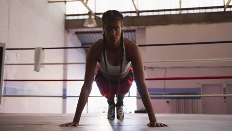 mixed race woman working out in boxing gym