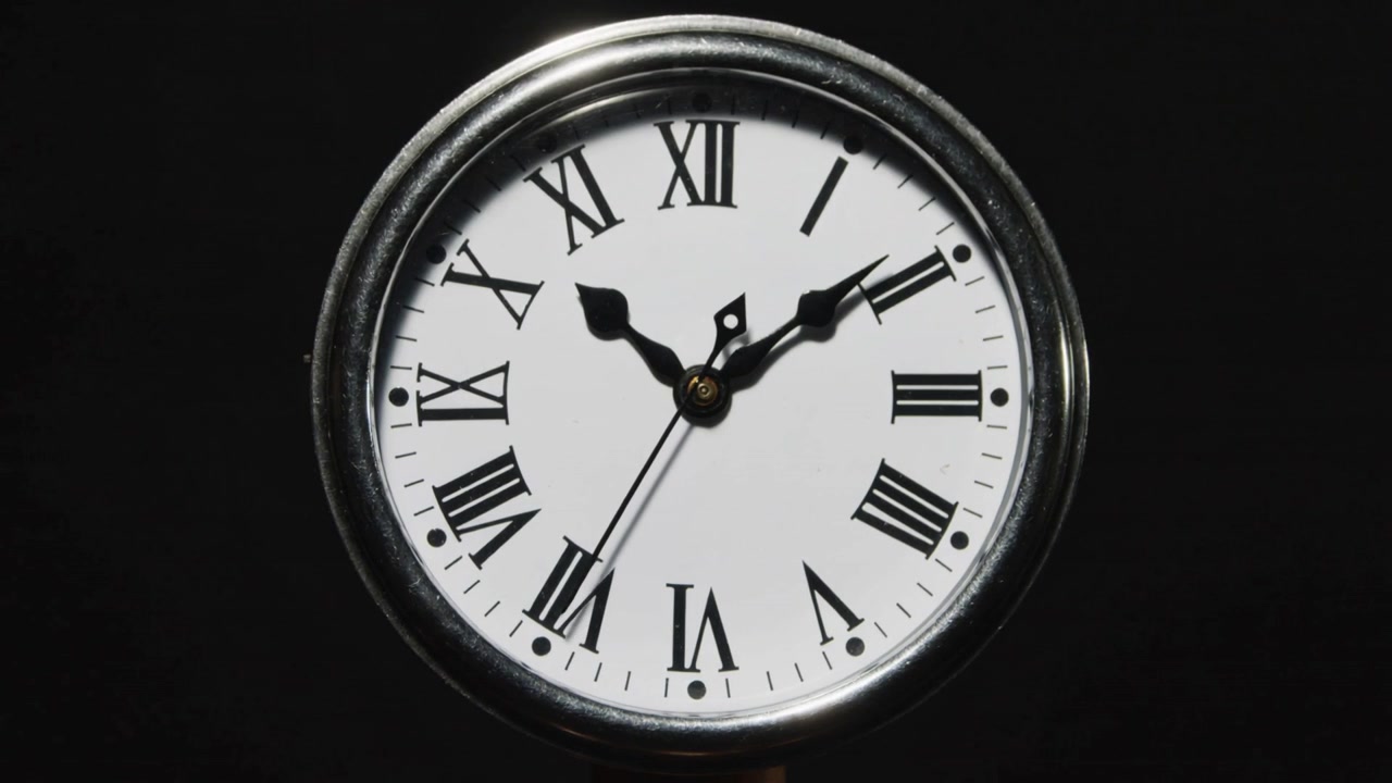 Advancing second hand shifting minute and hour hands indicating time in studio, with metal bezel