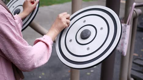 woman playing with circular exercise plates in a park