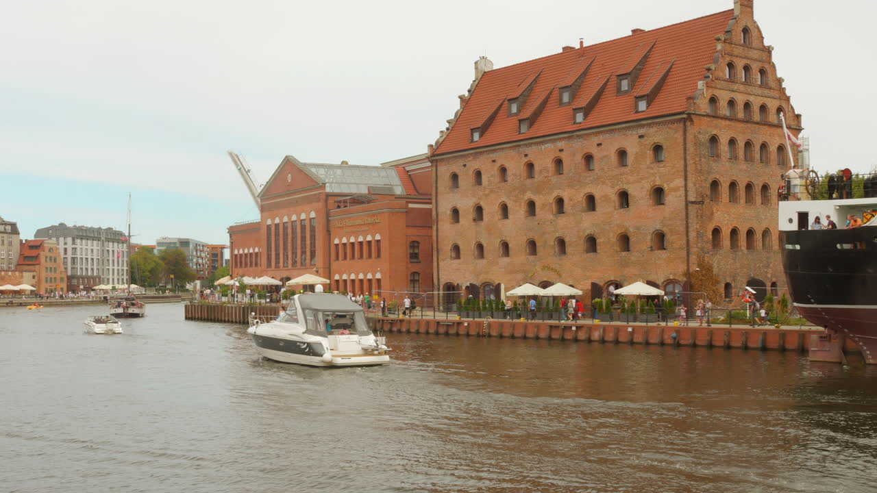 Shot of local ferries sailing on Motlawa river at Gdansk city center in Gdansk, Poland