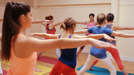 instructor assisting a group of people in exercise