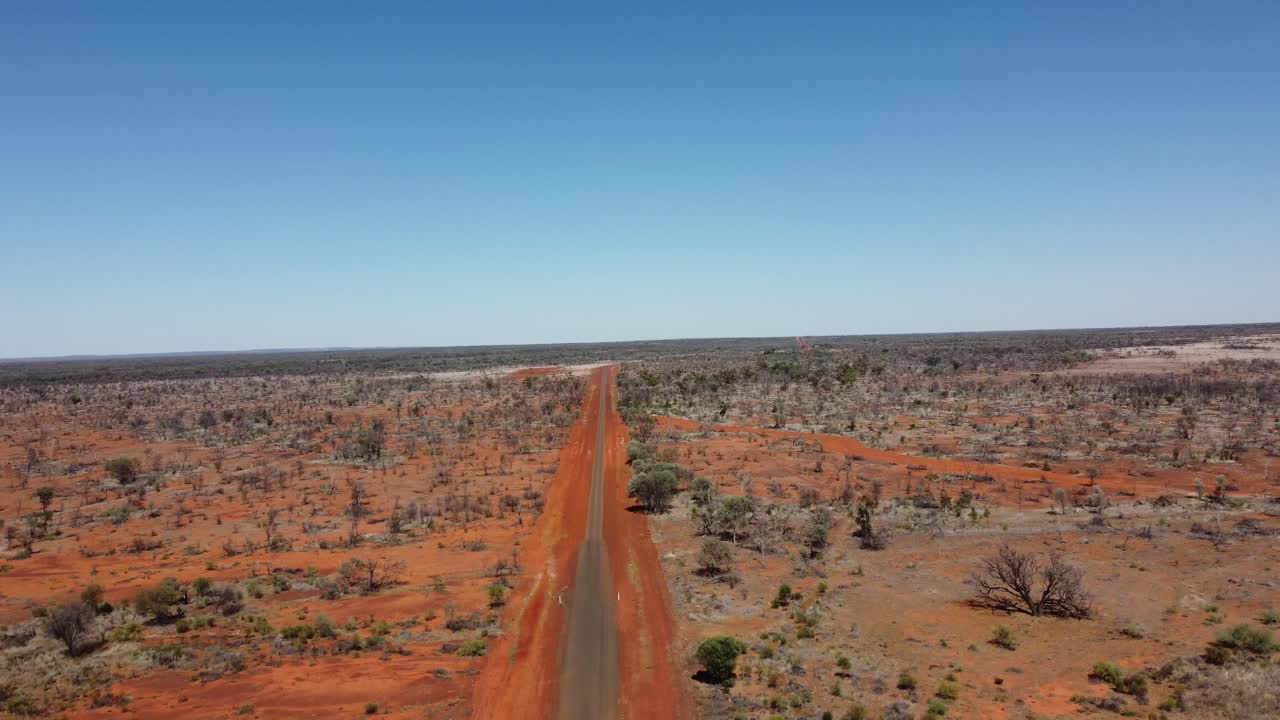 Drone ascending over country sealed and unsealed roads in the Australian Outback