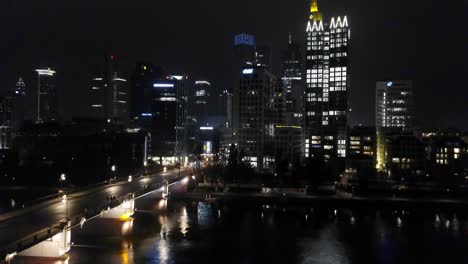 lowering down in front of the skyscrapers of frankfurt am main at night