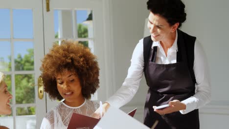 friends placing order to waitress