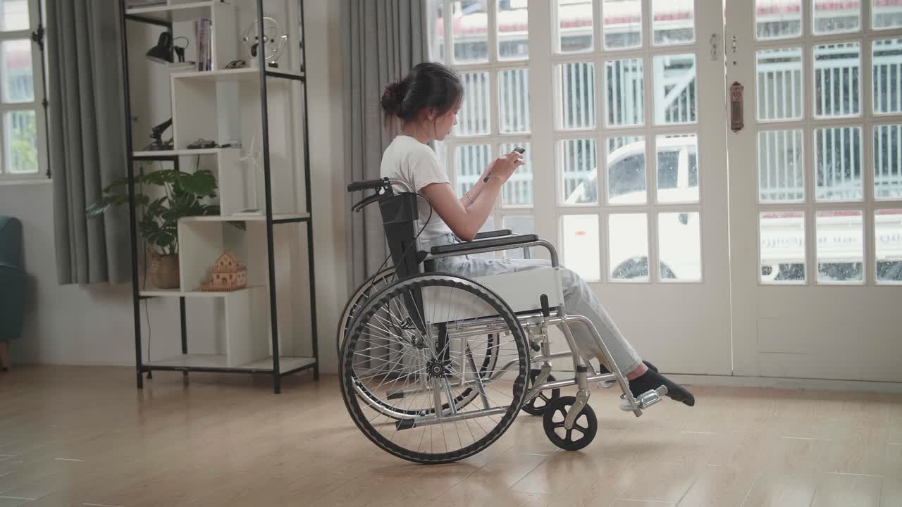 Woman in Wheelchair using Mobile Phone