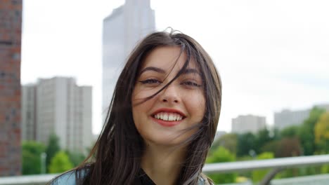 portrait of smiling young woman in the city