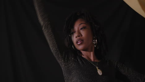 Portrait-head-shot-of-young-African-American-women-with-black-background