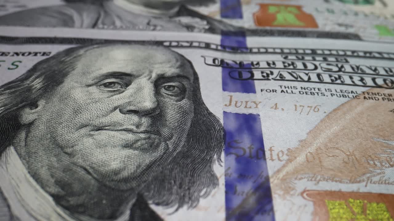 los billetes macro de 100 dólares estadounidenses, los billetes de dinero en efectivo, la textura del rostro de franklin.