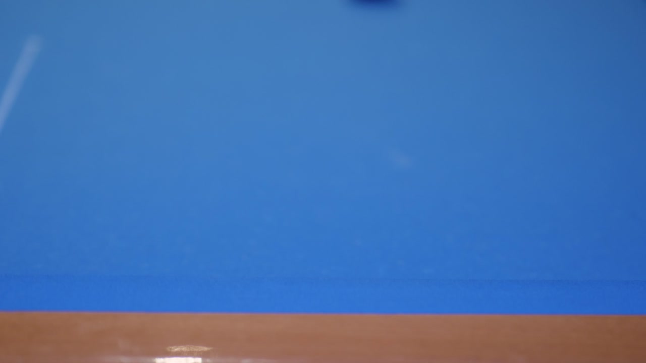 Bola snooker yang dipecah di meja snooker biru.