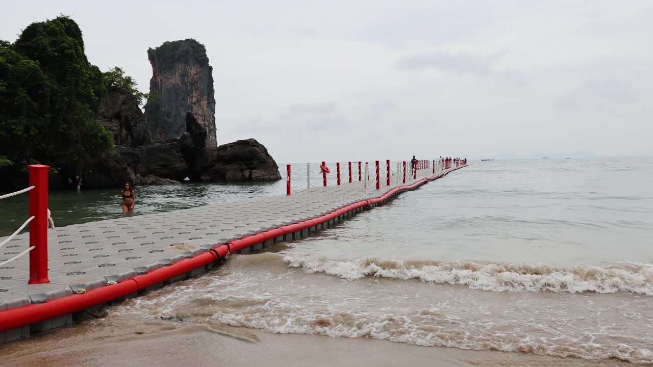 Waves lap against a floating pier