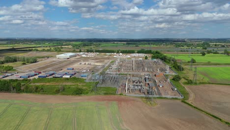 aerial video of energy grid infrastructure and high-voltage transformer station england